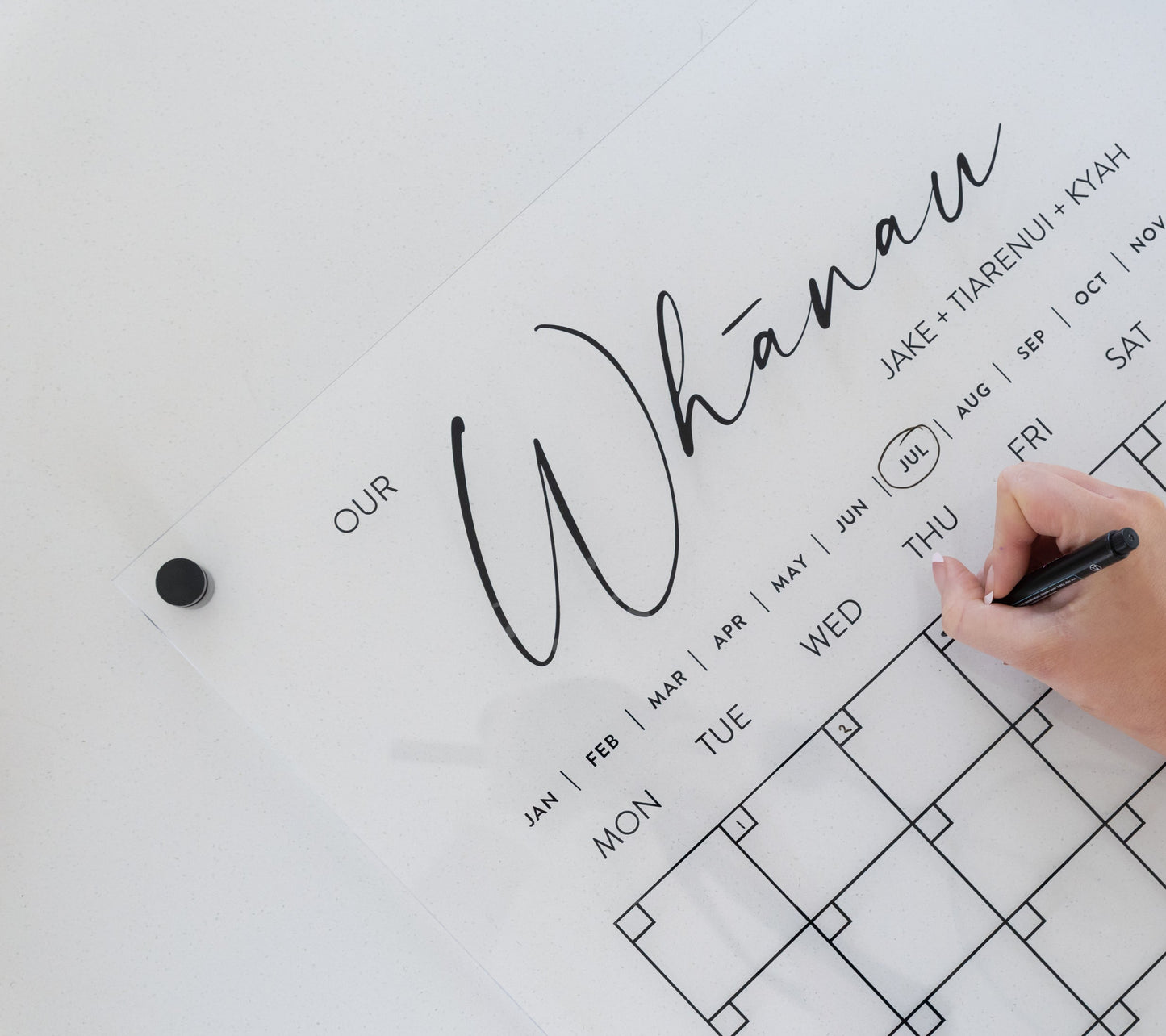 Minimalistic acrylic planner mounted with black standoff bracket, showcasing elevated modern design.